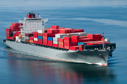 A container ship arriving in port on a very calm day.