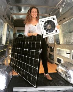 custom van ideas, living on the road, woman installing solar panel