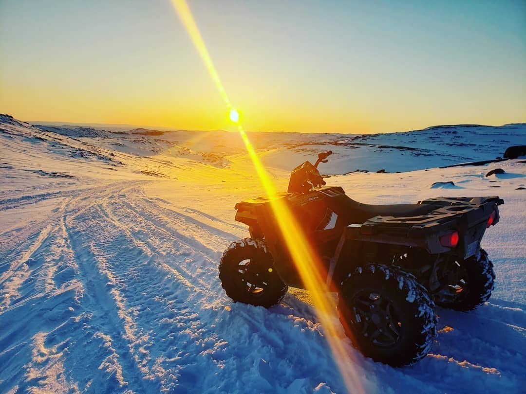 atv at sunset in snow