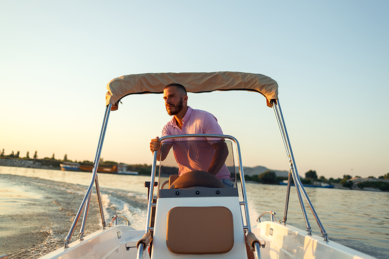 boat captain driving powerboat for boat rental business