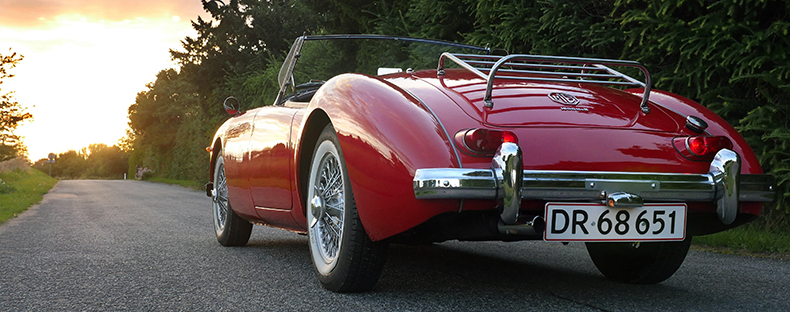 classic luxury red car on country road