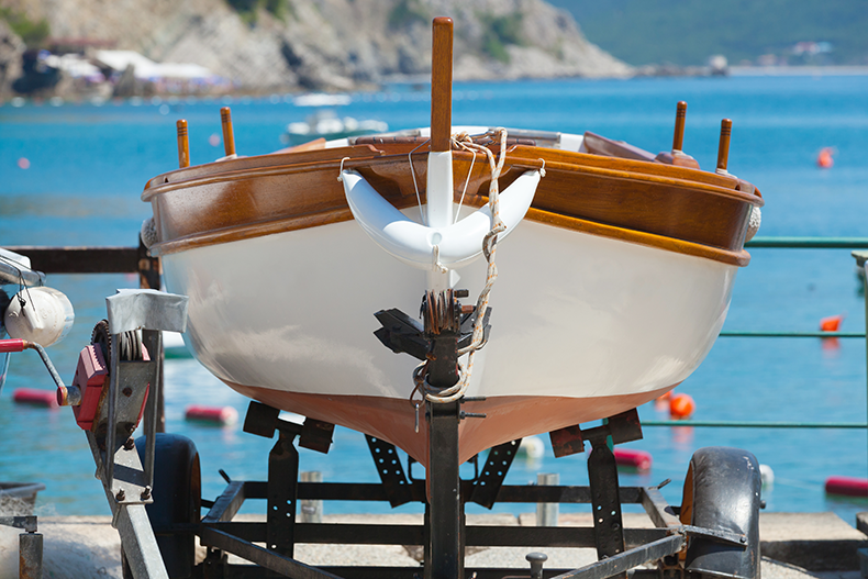 wood boat on trailer by the dock