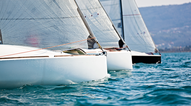 three sailboats in the water