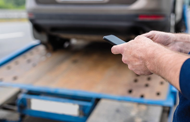 person on phone preparing for shipping a car cross country