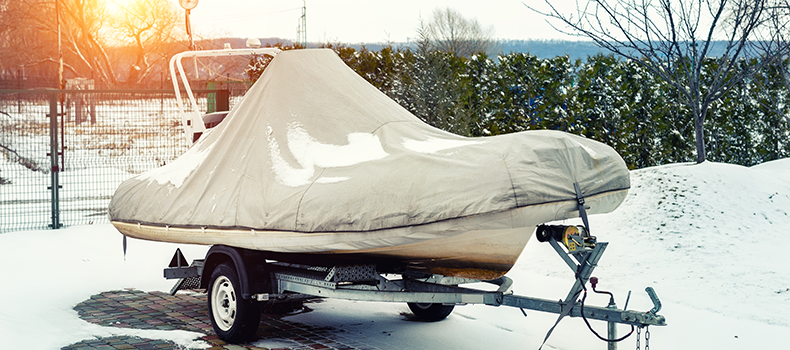 Covered boat on trailer in snow - shipping a boat in the winter example