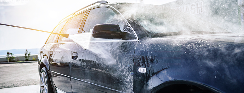 Someone washing a high-value car before transport