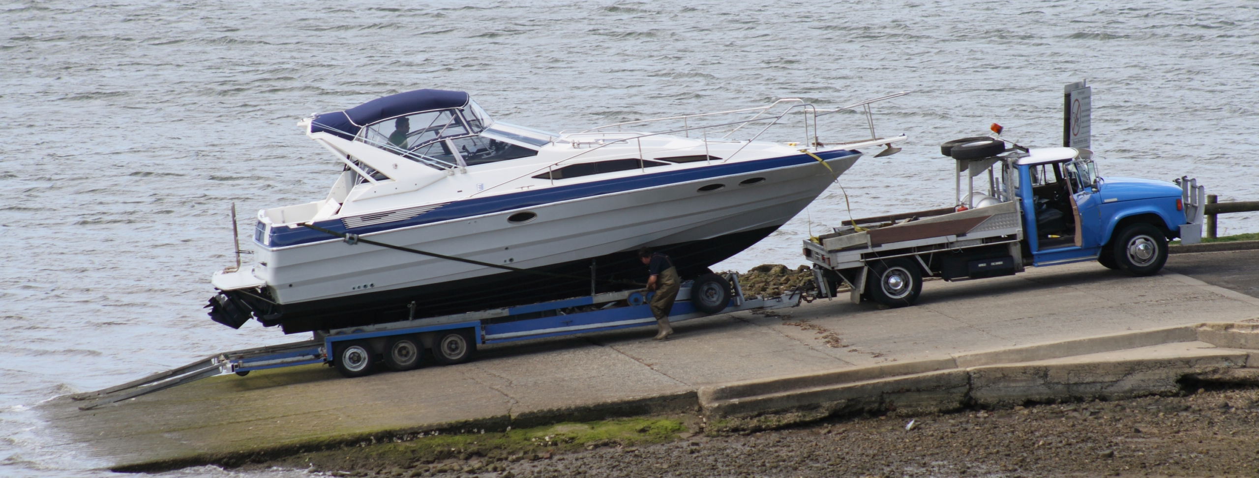 Boat transportation carrier on a dock with motor boat