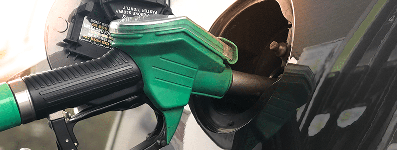 green gas pump filling car