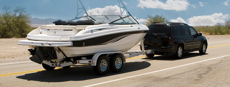 boat with boat shipping insurance being pulled by suv