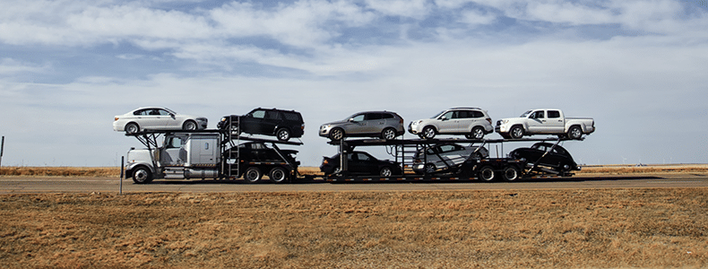 Open transport vehicle shipping on road