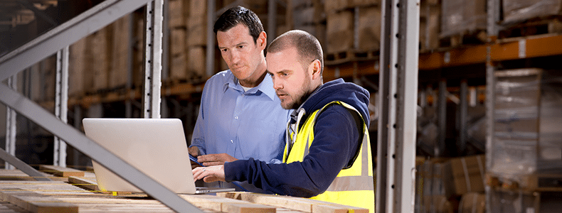 Two men reviewing LTL freight pickup process