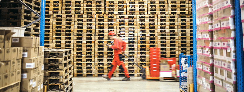 businness shipper in front of pallets for shipping