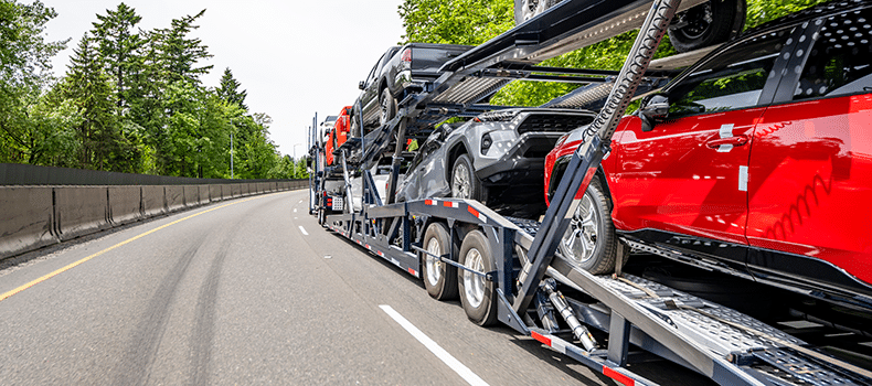open vehicle transport shown on country road 