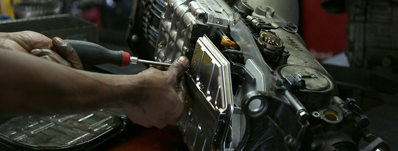 person working on a transmission