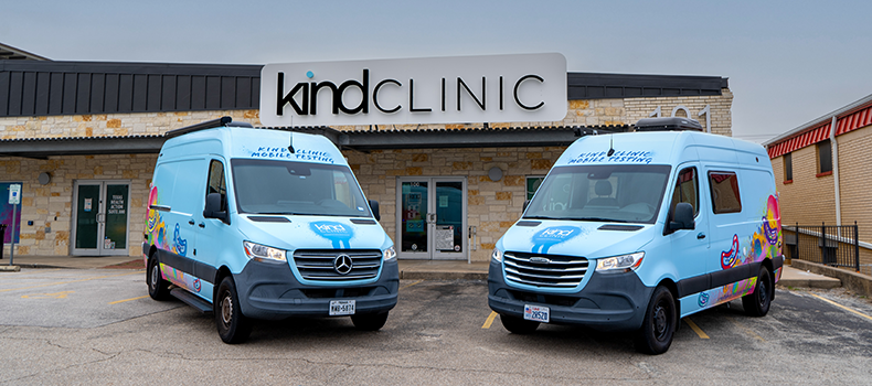 two colorful vans parked in front of kind clinic