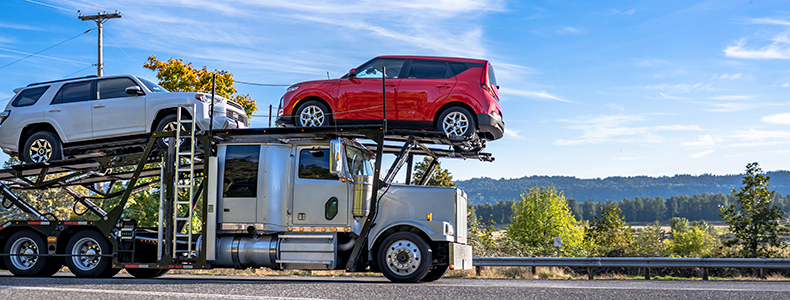 cars loaded on open trailer
