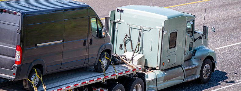 car loaded on open trailer for auto transport