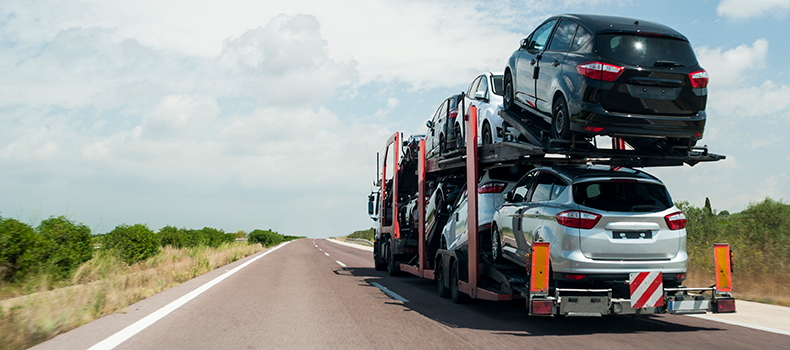 open transport trailer hauling vehicles
