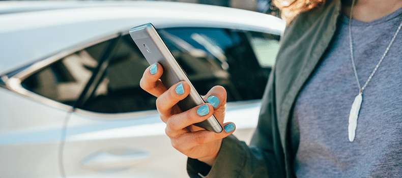 person booking college car shipping with uShip on their phone