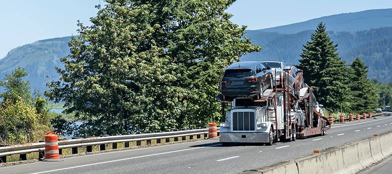 open vehicle trailer driving on road
