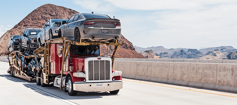 open trailer carrying multiple vehicles