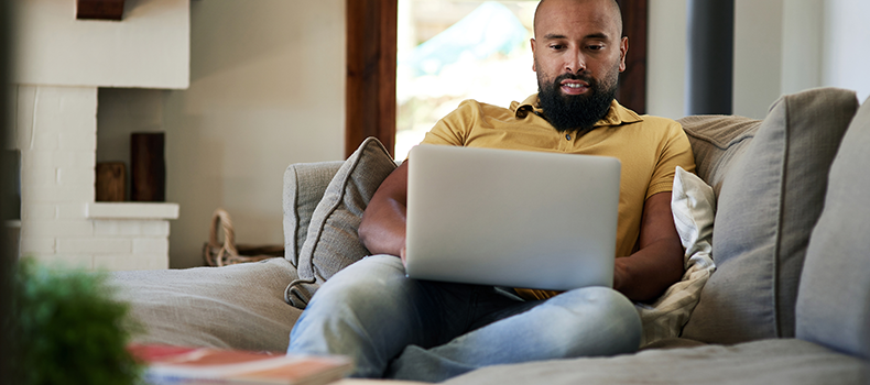 man on couch researching cargo insurance