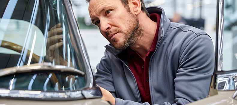 man inspecting car before shipping