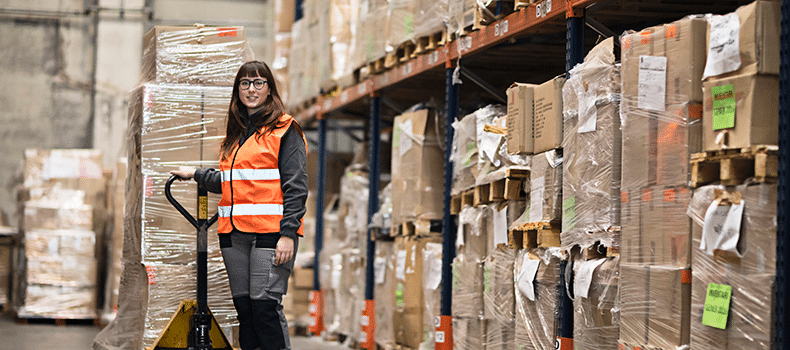 woman in warehouse prepping a shipment for pickup