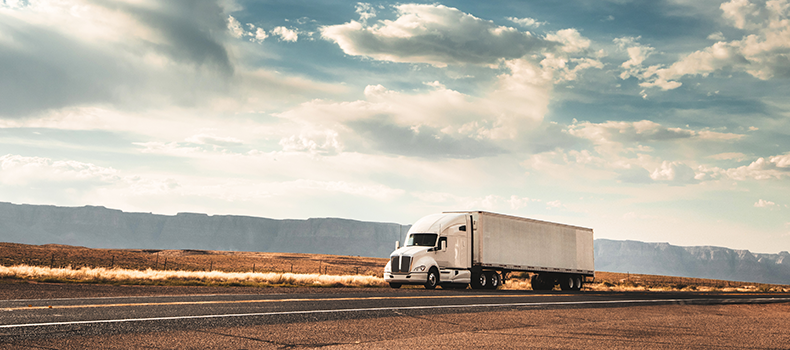 freight truck driving down the road