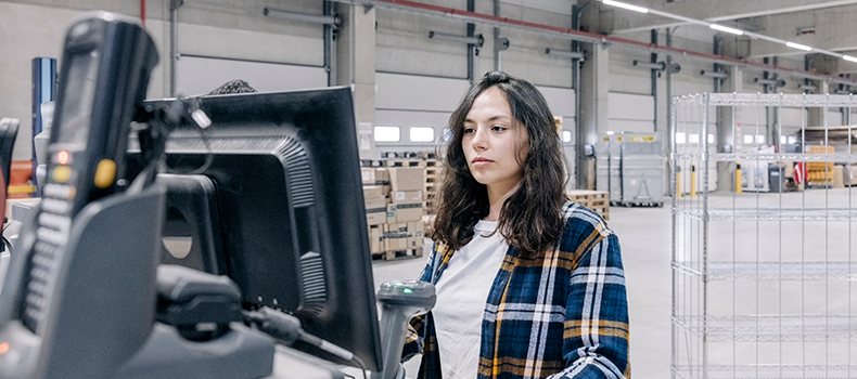 woman in warehouse preparing to ship LTL freight for business