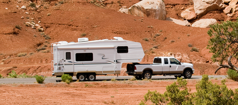 RV hooked up to truck in the desert