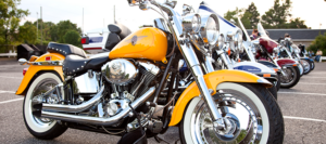 Cost-Saving Strategies for Motorcycle Shipping in 2026 1 yellow motorcycle next to other motorcyles