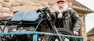Cost-Saving Strategies for Motorcycle Shipping in 2026 2 older man standing next to motorcycle on trailer